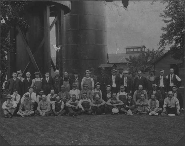 Railroad employees by depot, water tank, and park in Fremont, Nebraska, 1921.