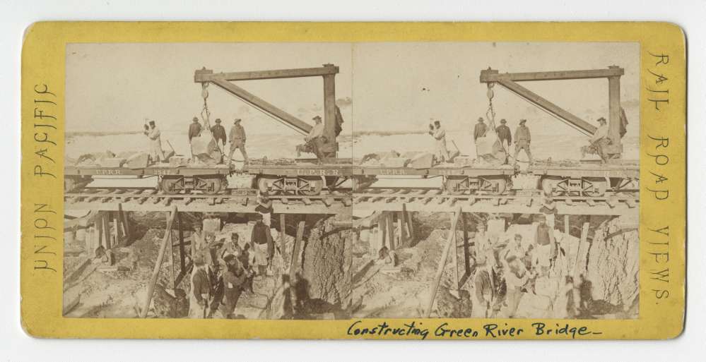 A Stereo card showing the building permanent bridge at Green River, Wyoming