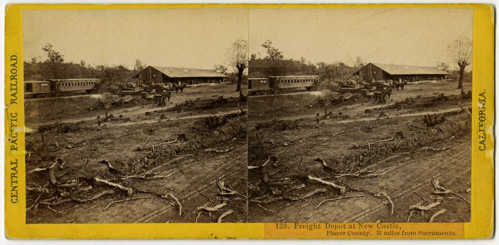 A stereo card showing a boxcar and passenger car next to the freight depot at Newcastle, California