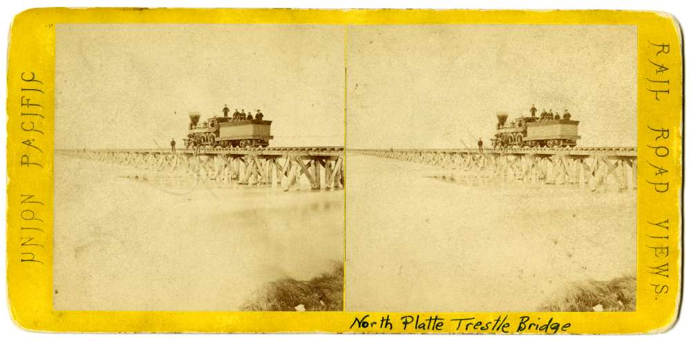 A stereo card showing the North Platte Trestle Bridge and Locomotive #54