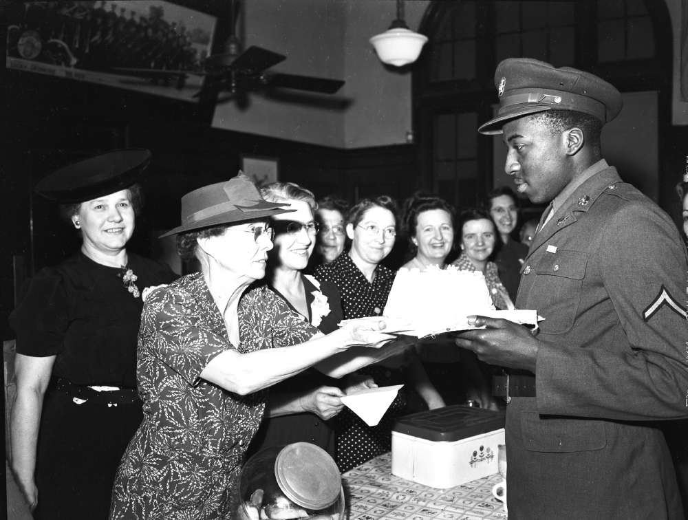 A U.S. serviceman receives a birthday cake from volunteers in North Platte, Nebraska