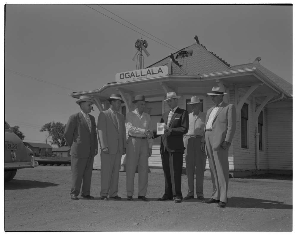 Edd H. Bailey, president of Union Pacific, awards War Bond of Courtesy to slogan winners