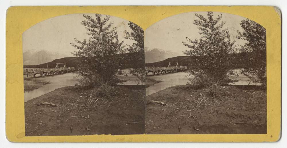 A stereo card showing a bridge and the Wasatch Mountains, Utah