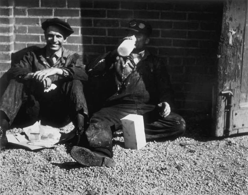 Railroad employees pause for a lunch break outside of the Omaha Shops