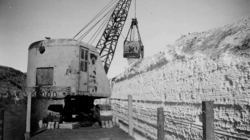Union Pacific crews use crane mounted to flatcar to remove snow after the 1949 blizzard